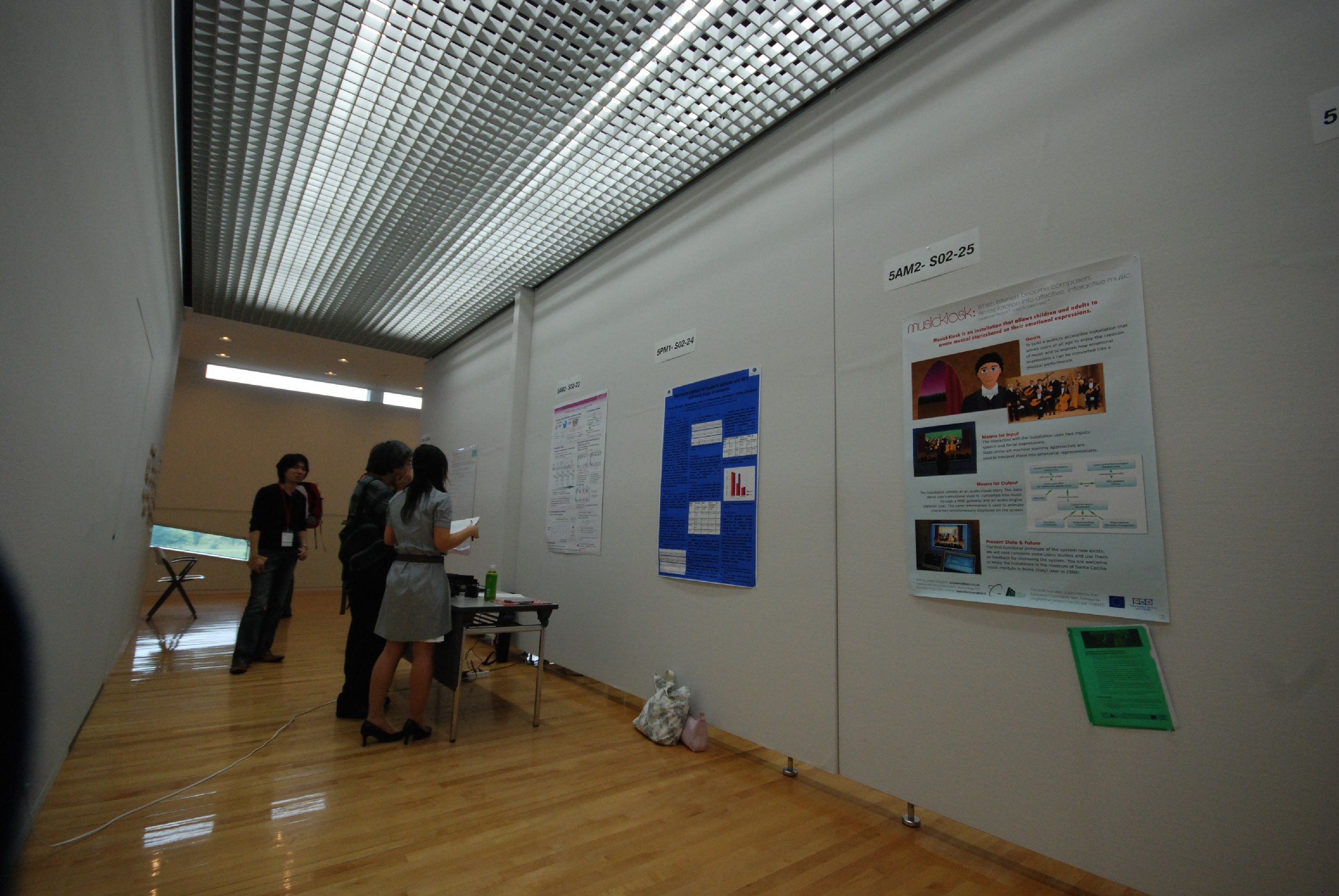 people visiting the poster session where CALLAS was showing its approach to emotional music